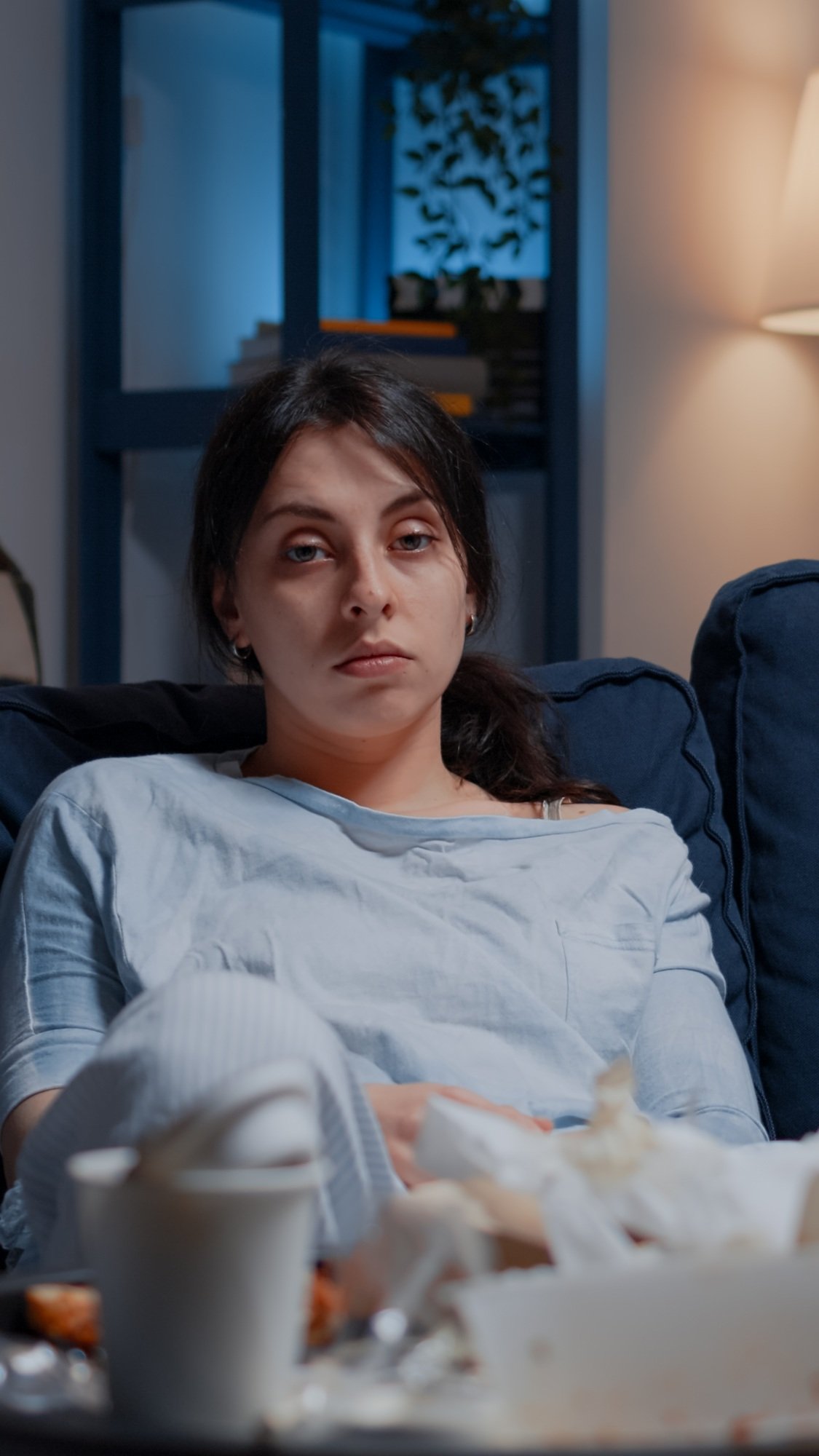 Portrait traumatised, frustrated woman sitting alone on couch